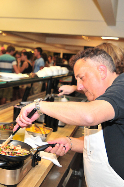 Man in apron cooking an omelet