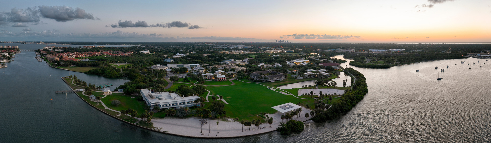 Sunrise over a college campus on a peninsula stretching into a bay